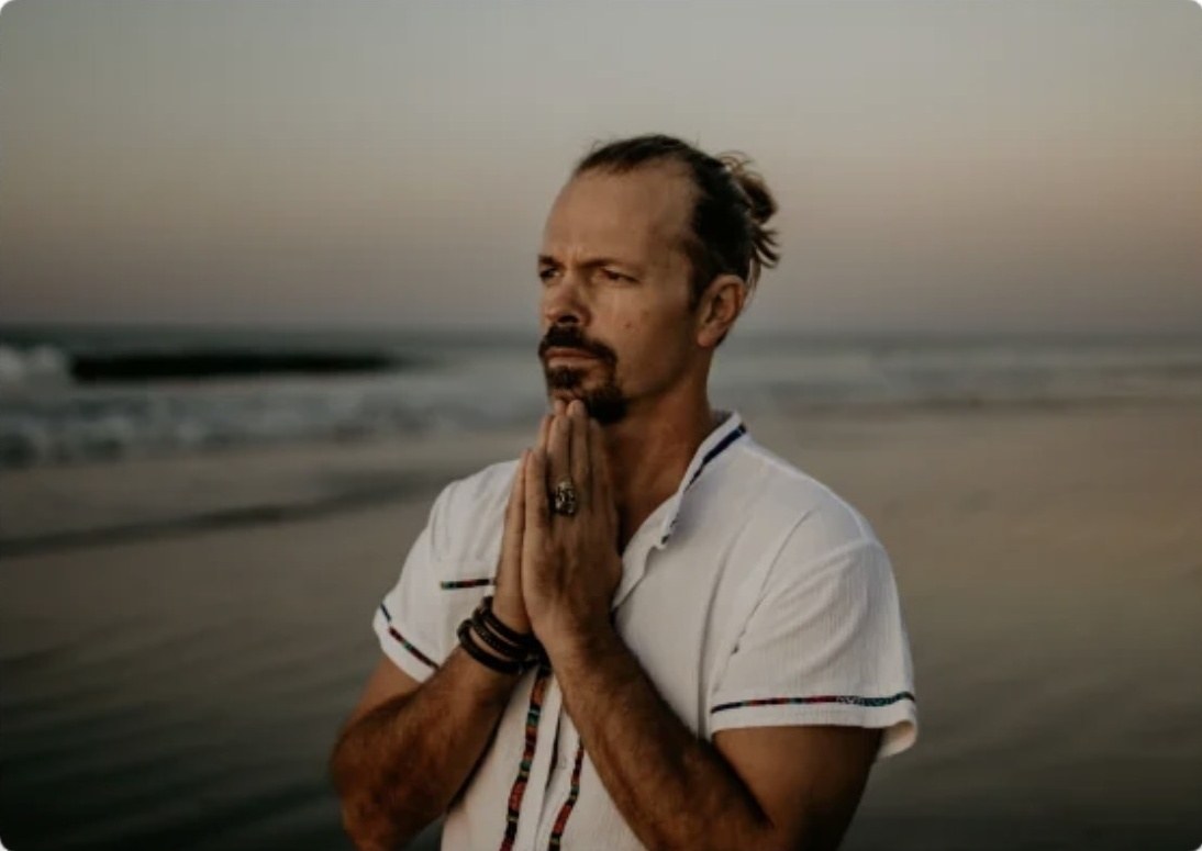 Dr. Aaron Burt in quiet reflection on the beach at dusk